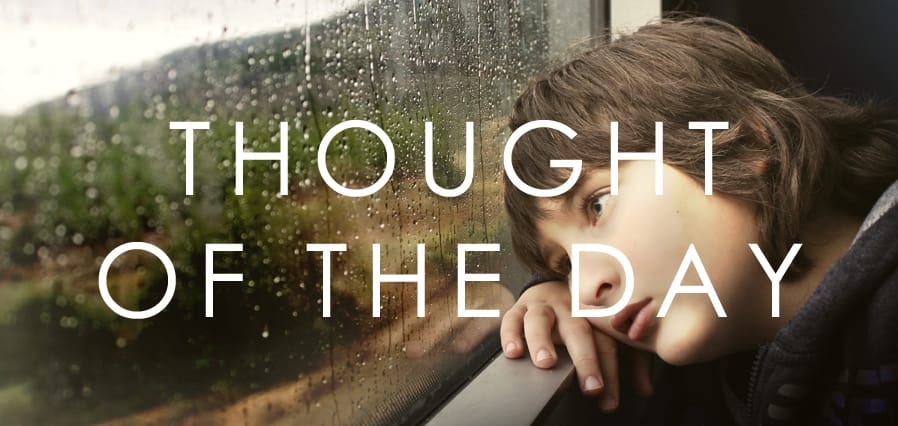 Thought of the Day: Boy gazes out rainy window, deep in thought on a wet day. Reflection on life's moments.