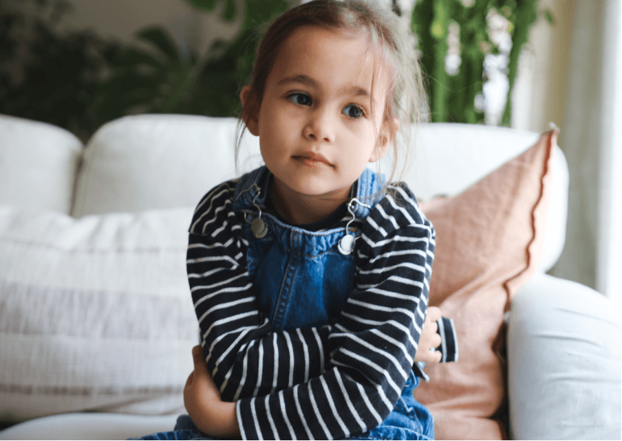 Young girl with arms crossed, illustrating the gut-brain connection in children and trusting your gut feelings.