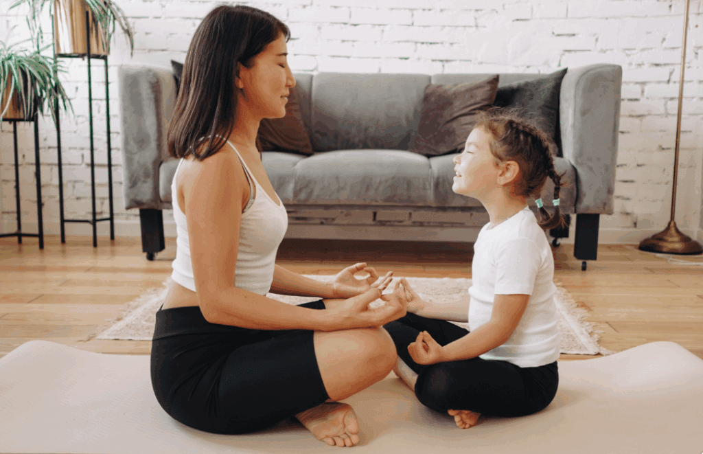Natural pediatric anxiety relief: Mom and child meditate, promoting stress management and well-being through mindful practices.