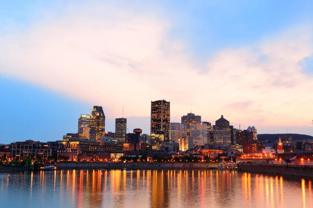 North Carolina virtual visit: City skyline at dusk with water reflections, showcasing urban beauty for online exploration.