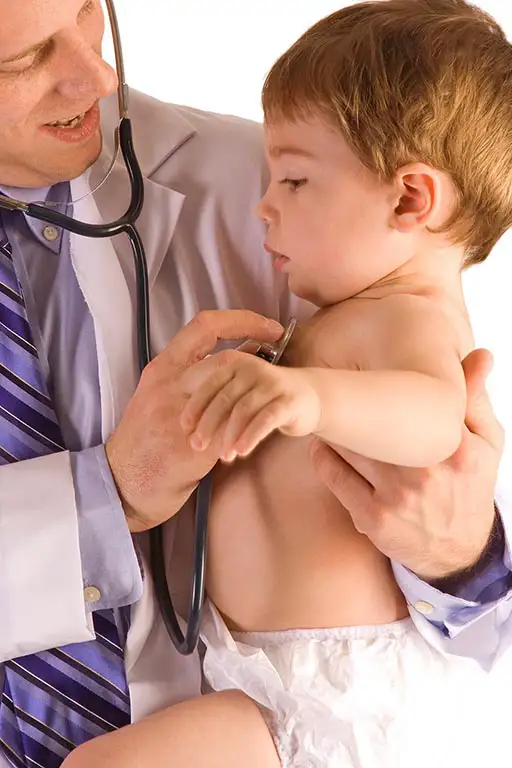Holistic pediatrician examining a baby with a stethoscope in a judgment-free environment. Child health checkup.