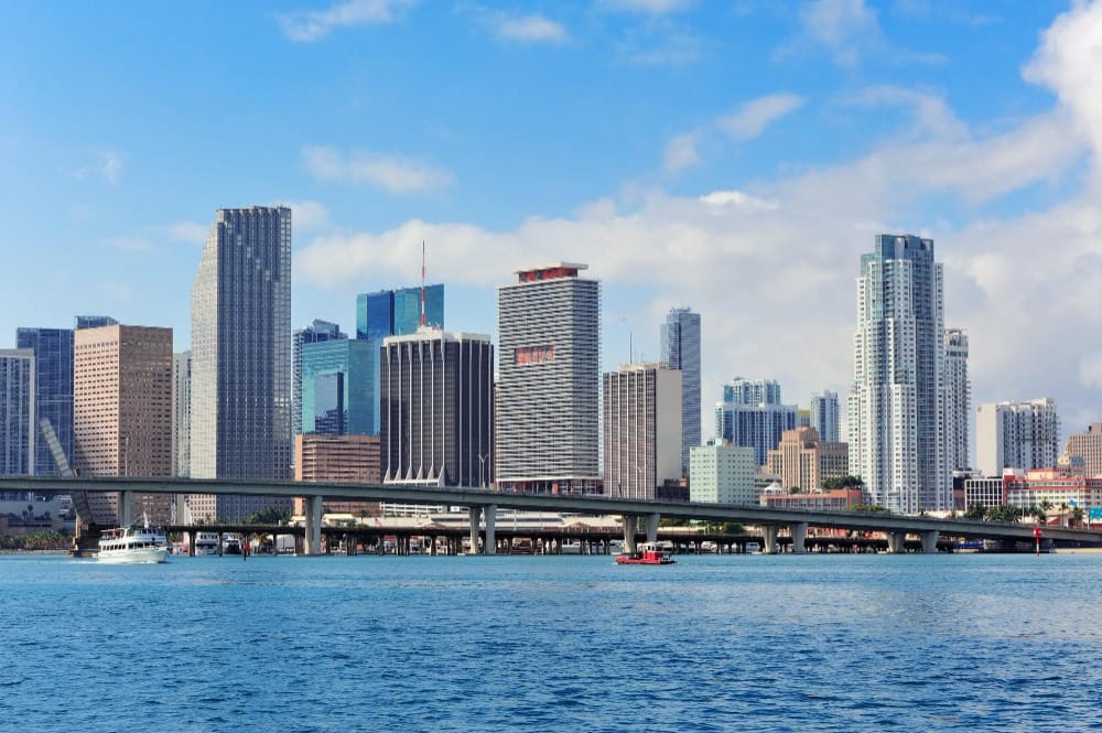 Miami Florida skyline view from the water, showcasing a vibrant cityscape and clear blue sky. Virtual visit to Florida