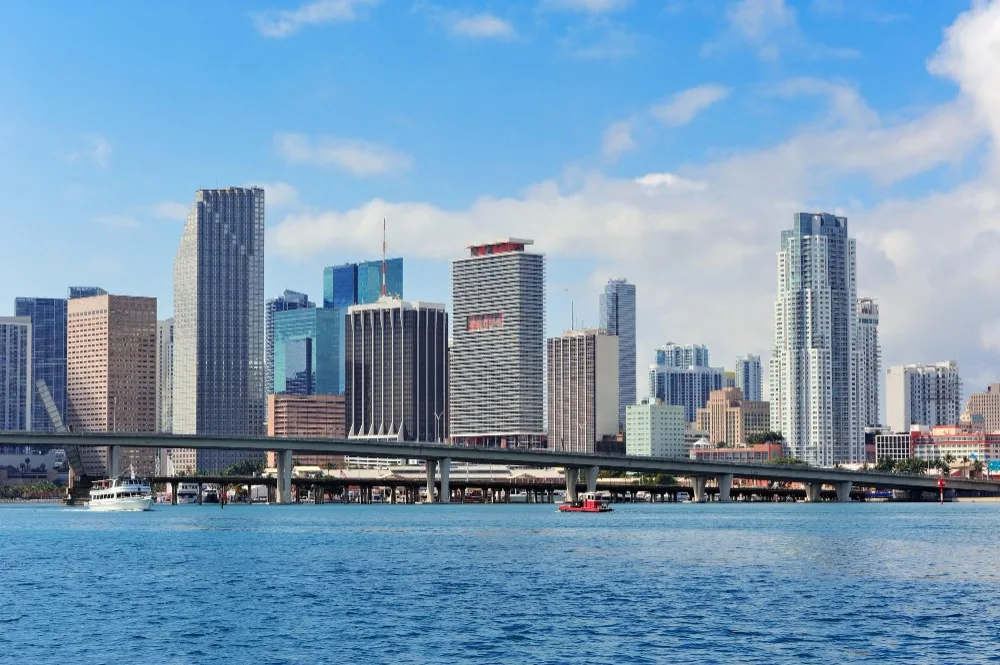Miami Florida skyline view from the water, showcasing a vibrant cityscape and clear blue sky. Virtual visit to Florida