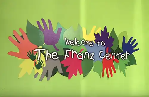 Logo of The Franz Center pediatric practice in Orlando, FL on a green backdrop